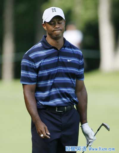 Tiger Woods of the U.S. reacts to his approach shot at the ninth hole during the first round of the Memorial Tournament at Muirfield Village Golf Club in Dublin, Ohio June 3, 2010. 