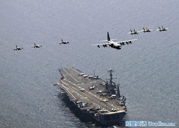 A U.S. Marine Corps C-130 Hercules aircraft leads a formation of F/A-18C Hornet strike fighters and A/V-8B Harrier jets over the aircraft carrier USS George Washington (CVN 73) in the East Sea of Korea, July 27, 2010. (Xinhua/Reuters File Photo)