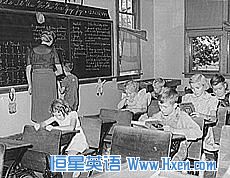 In this photo of an old, one-room classroom in Grundy, Iowa, the 7-year-old boy getting help at the blackboard is the only second-grader in the class.