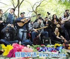 People sing John Lennon and Beatles songs as they gather around the Imagine mosaic in Strawberry Fields in New York's Central Park to celebrate the birthday of John Lennon in New York, October 9, 2010.