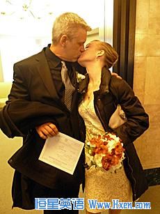 Just married! Ty and Elena kiss minutes after saying their vows. He is holding their wedding license.