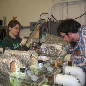 University of Michigan graduate students monitor a water quality experiment.