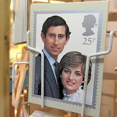 A postcard of a commemorative stamp celebrating the wedding of Prince Charles and Lady Diana Spencer in 1981 is displayed outside a philatelists in London