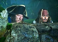 Captain Sparrow (Johnny Depp, right) and Hector Barbossa (Geoffrey Rush) spy on a Spanish encampment during the search for the legendary Fountain of Youth.