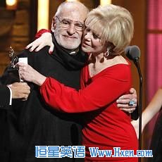Larry Kramer, left, is hugged by Daryl Roth after they won the Tony Award for Best Revival of a Play for 