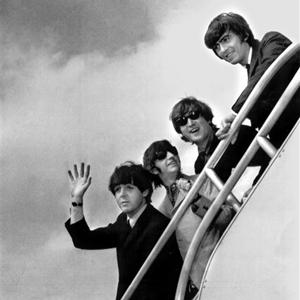 The Beatles, (from left) Paul McCartney, Ringo Starr, John Lennon and George Harrison board a plane for England at a New York airport in 1964.
