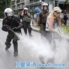 A policeman sprays tear gas as a protester walks away during an anti-austerity rally in Athens June 29, 2011. 