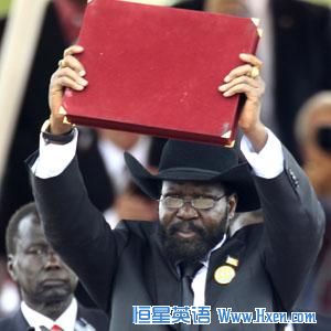South Sudan's President Salva Kiir displays the transitional constitution of the Republic of South Sudan after signing it into law during the Independence Day celebrations in the capital Juba, July 9, 2011