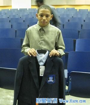Jamarcus Preston, who will be entering 6th grade at Obama Academy, shows off his new school uniform.