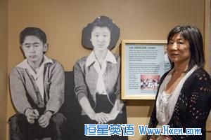 Shirley Ann Higuchi, chairman of the Heart Mountain Wyoming Foundation, stands next to a life-size photo of her parents taken in the camp. 