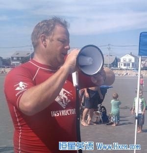 AmpSurf founder Dana Cummings commands the beach with his megaphone as he welcomes participants to a surfing class in Maine.   