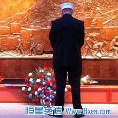 An honor guard pay his respect at the bronze firefighter memorial at the World Trade Center site in New York, September 11, 2011
