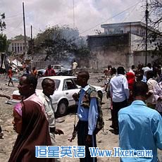 People mill around the scene where a suicide attack took place in Somalia's capital Mogadishu, October 4, 2011.  