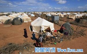Refugees stand outside their tent at the Ifo Extension refugee camp in Dadaab, near the Kenya-Somalia border (File)