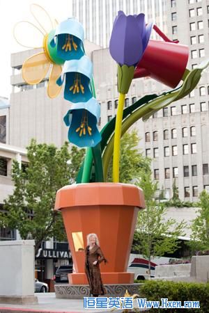 Artist Ginny Ruffner stands in front of her 28-foot [8.5 meter] aluminum-and-steel flowerpot. Seattle, Washington,  2011.